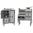 A miniature vintage-style kitchen set that fits American Girl® dolls is displayed side-by-side against a solid white background. On the left is a white three-door wooden icebox with one upper door open, revealing a tiny orange bowl inside. On the right stands a matching white vintage cookstove with an open oven door displaying a baking dish, four curved legs, black cooktop burners, and small utensils resting on its surfaces.