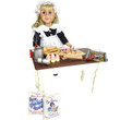 On white background, a  kitchen maid stands at farmhouse table holding a whisk and the included baking tools and cookies on the counter below her.