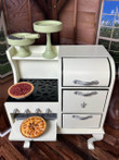 In doll kitchen setting, our 1930s white oven stove for 18 inch dolls has the apple pie coming freshly out of the oven and the pecan pie resting on the cooktop. The two pie stands are stored on the oven's shelf above. In doll kitchen setting, our 1930s white oven stove for 18 inch dolls has the apple pie coming freshly out of the oven and the pecan pie resting on the cooktop. The two pie stands are stored on the oven's shelf above.