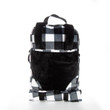 A plush doll-carrier backpack featuring a solid black front panel and shoulder straps layered over a black and white buffalo plaid background. A black top handle extends from the top, and a matching rolled-up plaid sleeping bag is secured horizontally with straps beneath the main bag against a plain white background.