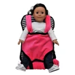 A doll with dark hair and a light complexion is secured in a plush doll-carrier backpack facing forward against a plain white background. The backpack features a vibrant pink front carrier and shoulder straps set against a black and white horizontally striped main bag.