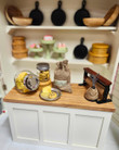 18 inch doll sized shop counter with foods items in jars and other vintage style stock items on shelves.