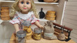 Blonde 18 inch doll standing at counter with 3 mini mason jars filled with 18 inch doll cookies.