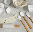 baking tools displayed on a baking board with flour showing