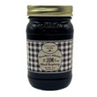 A jar of Caroline's Kitchen Black Raspberry Jam from the Little House on the Prairie® collection, featuring a brown gingham label with a gold lid, displayed against a solid white background.
