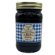 A jar of Caroline's Kitchen Elderberry Jelly from the Little House on the Prairie® collection, featuring a dark blue and white gingham label with a gold lid, displayed against a solid white background.