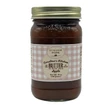 A jar of Caroline's Kitchen Apple Butter from the Little House on the Prairie® collection, featuring a pink gingham label with a gold lid, displayed against a solid white background.