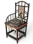 The image shows a rustic, hand-painted wooden armchair featuring twig-style accents, a deer and sun motif on the back panel, and a patterned fabric seat cushion. Tiled toward the left.