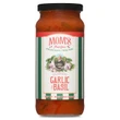 A studio product shot of a 16 oz jar of Mom's Classic Garlic and Basil Pasta Sauce against a solid white background. The jar has a black lid and features a vertical green-and-white striped label framing an illustration of a woman surrounded by garlic cloves and basil leaves.