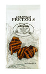 A white bag of East Shore Specialty Foods Seasoned Pretzels (Net Wt. 8 oz. / 227 g) featuring an oval logo illustration of a country house by the water, thin topographical line art patterns, and an organic-shaped clear window showing the seasoned pretzel sticks inside.