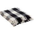 Add cozy charm to your space with this cozy  black and white buffalo check throw blanket, featuring a premium woven cotton construction and rustic fringe accents.