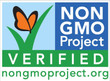 The official logo for the Non-GMO Project Verified certification program. The graphic features an orange and black monarch butterfly resting on a curved green blade of grass against a light blue sky. On the right, the text "NON GMO Project" is displayed in bold white lettering inside a dark blue block. The lower portion consists of a solid green rectangle with the word "VERIFIED" in spaced white capital letters, sitting above the website URL nongmoproject.org printed in green text at the very bottom.