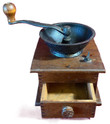 An antique wooden box coffee grinder with a dark cast iron hopper, a hand crank with a wooden knob, and a small drawer pulled open to show its clean interior.