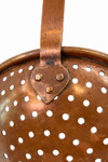 Macro detail of hand hammered copper rivets and antique metal texture on skimmer handle