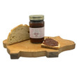 19 oz glass Mason jar of The Queen's Treasures Caramel Pecan Apple Butter on rustic pig shaped cutting board part of a loaf fresh bread behind the jar and bread with the spead on top of it in front. This is on a white background.