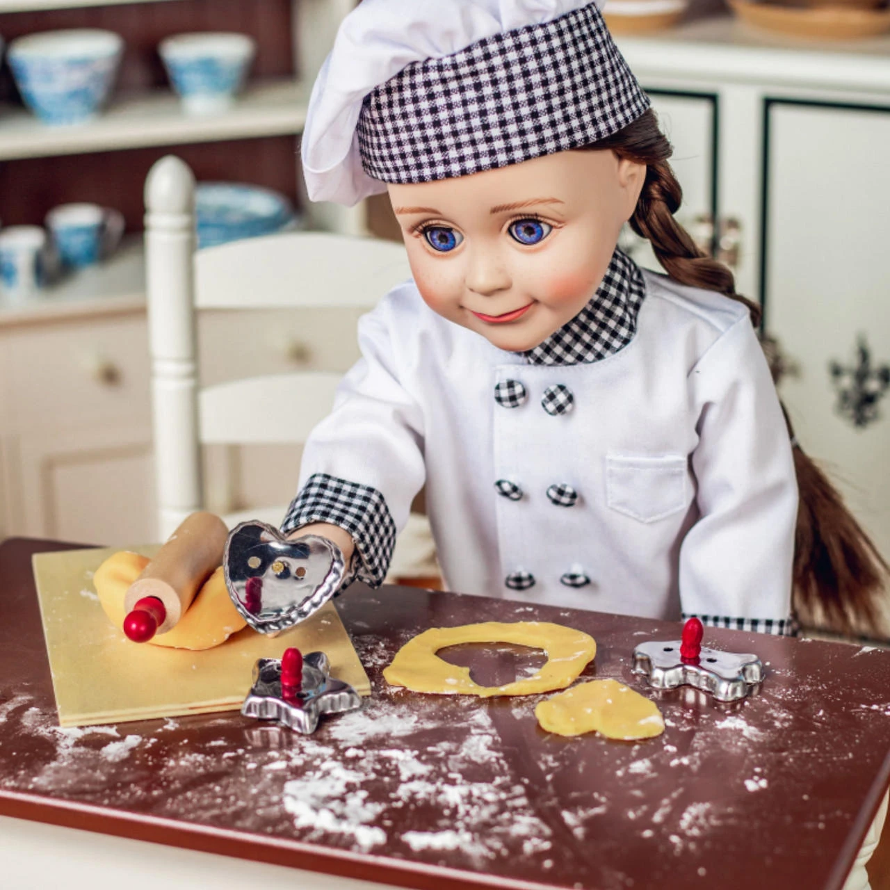 In 18 inch doll kitchen a doll chef is working with her 18 inch doll baked goods.