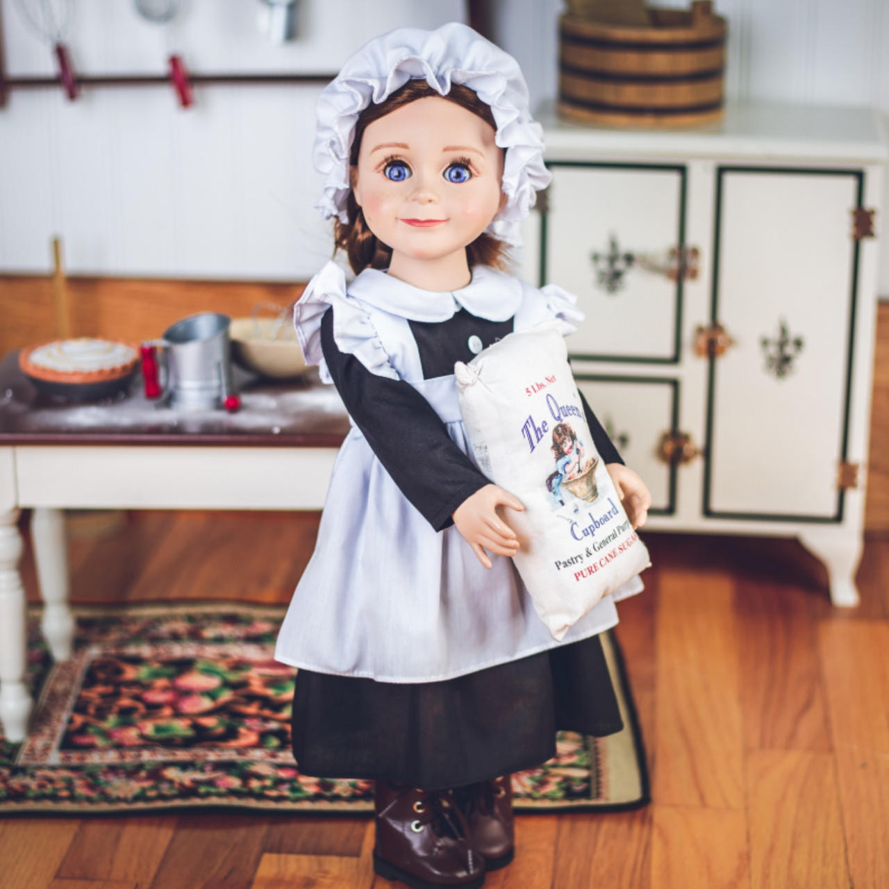 Laura Ingalls doll is wearing the Scullery Kitchen Maid Outfit, carrying a sack of flour. Vintage 18" doll accessories and 18 inch doll Ice Box, are in the background.
