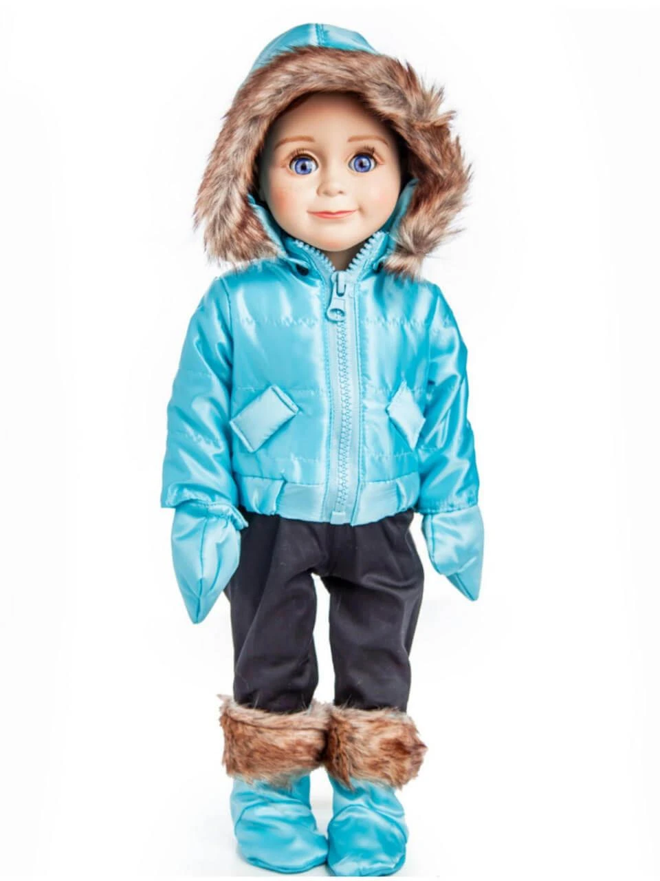 An 18-inch doll stands against a plain white background wearing a shiny, metallic blue winter puffer jacket with a faux-fur-trimmed hood, matching blue mittens, black pants, and blue winter boots with fluffy brown faux-fur cuffs.