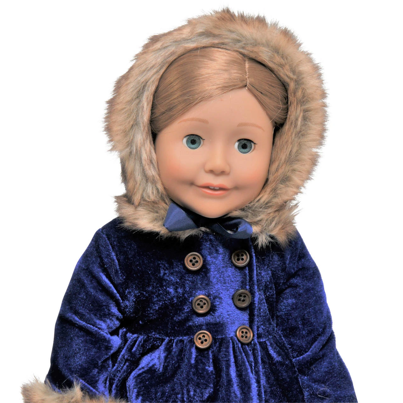 A close-up shot of an 18-inch doll with blue eyes and light brown hair, standing against a solid white background. She is wearing a deep royal blue velvet winter coat with dark double-breasted buttons, paired with a matching blue velvet bonnet trimmed in fluffy brown faux fur.