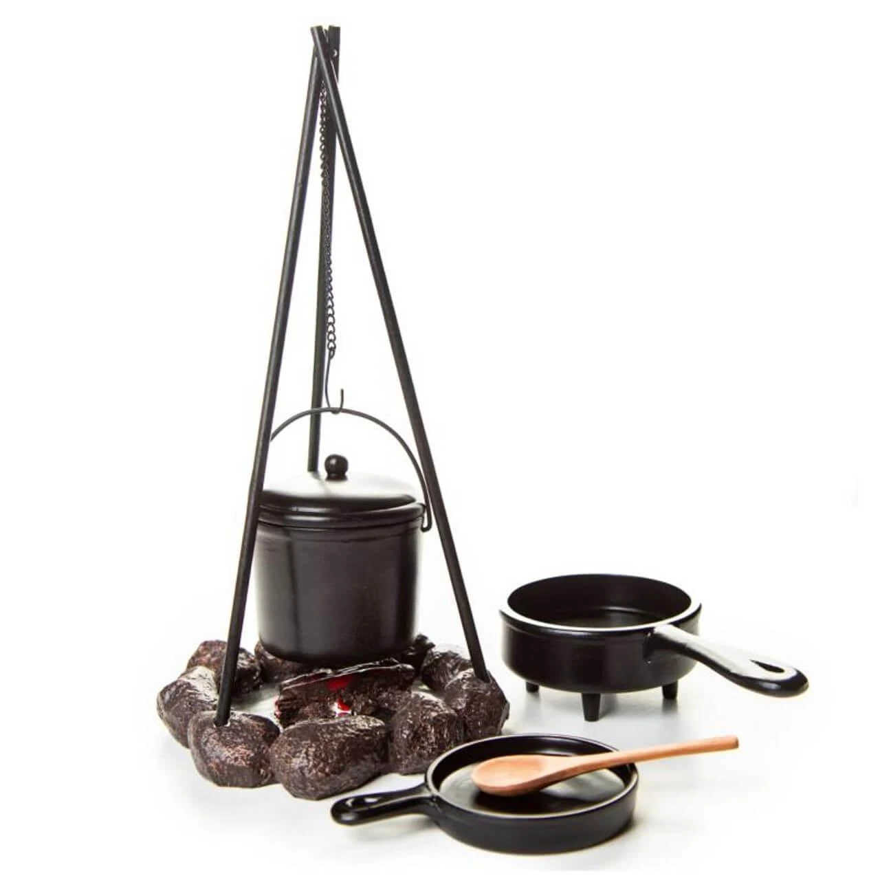 A miniature black campfire cooking set featuring a tall tripod suspending a lidded pot over a faux stone fire ring, alongside a small saucepan, skillet, and wooden spoon against a white background.