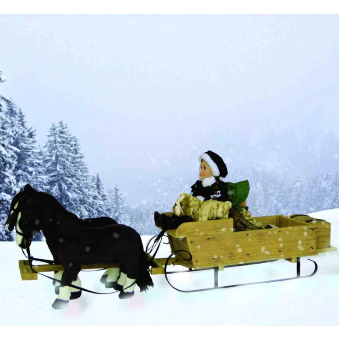 An outdoor winter scene of 18 doll sleigh being pulled by two 18 inch doll horses.