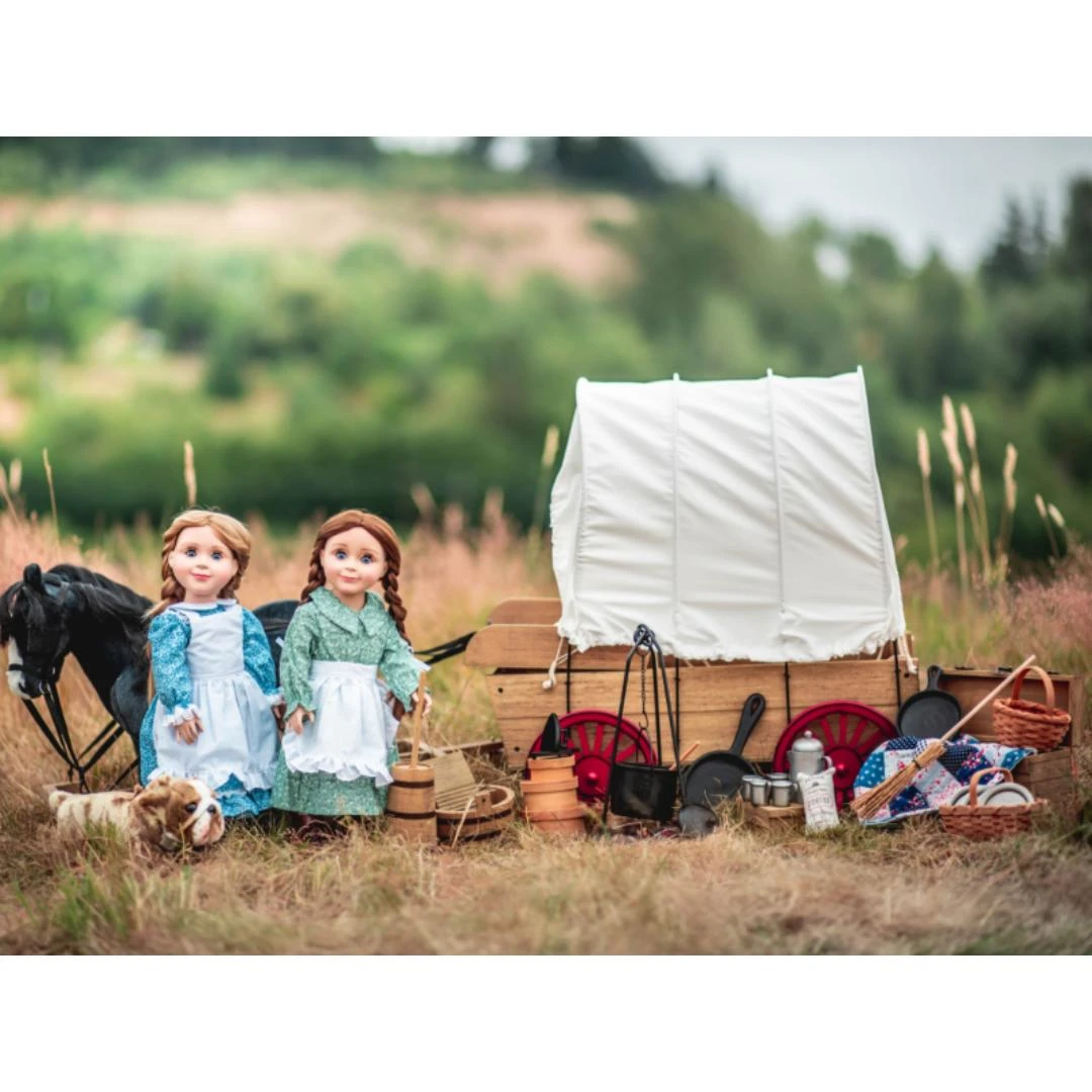 In outdoor play scene, our Laura and Mary Ingalls dolls stand next to the 18 inch doll covered wagon.