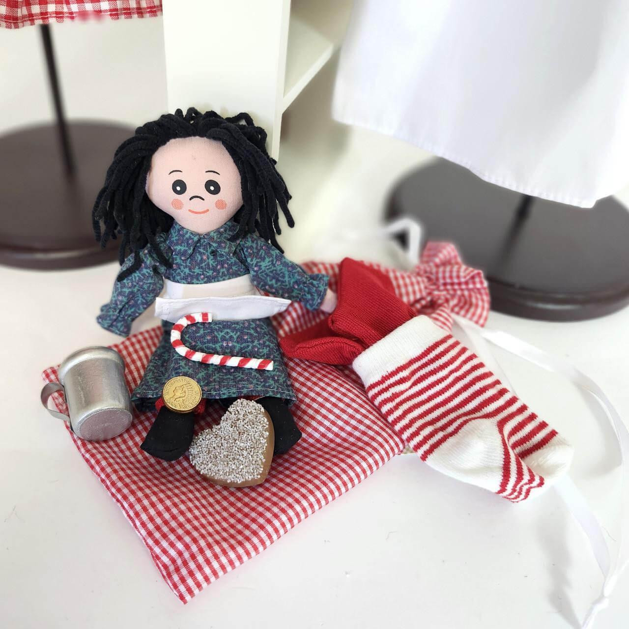 The Charlotte ragdoll features an authentically designed removable calico dress, apron, red gaiters and curly yarn hair and the accessories are perfectly sized for little 18 inch doll hands.