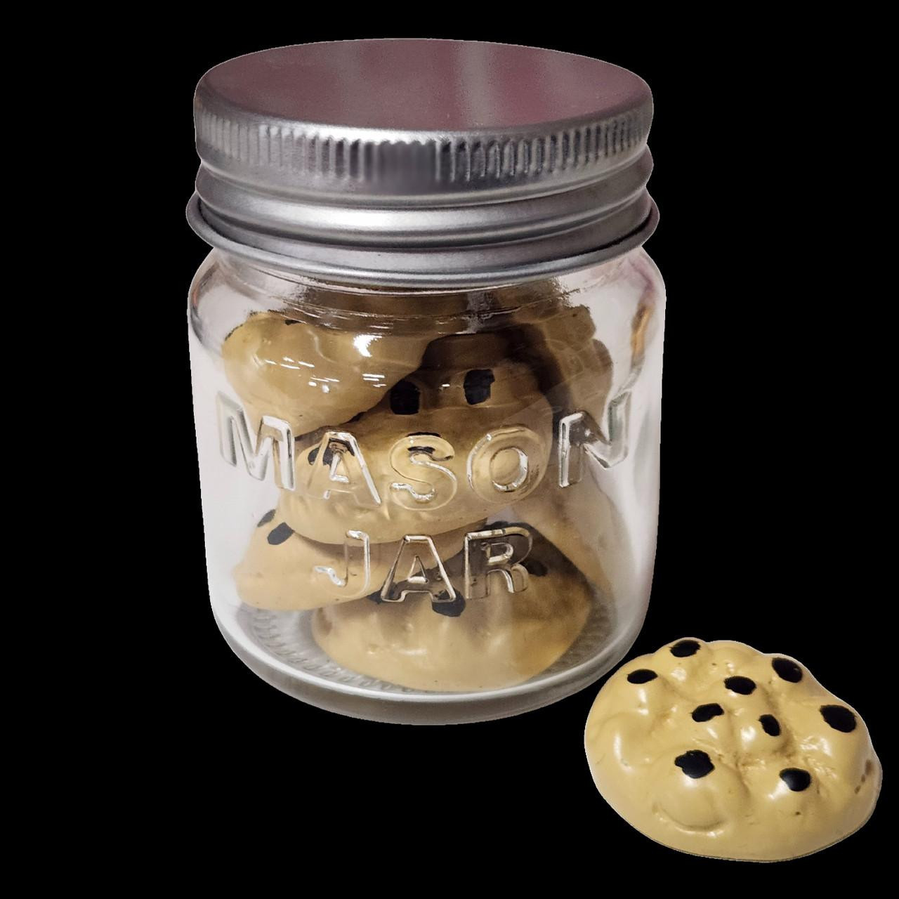 Close up image of jar with 18 inch doll sized chocolate chip cookies.