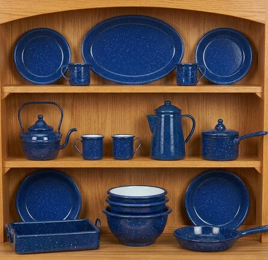 A matching set of Little House on the Prairie® blue enamel camping tableware with white speckles arranged on wooden shelves.