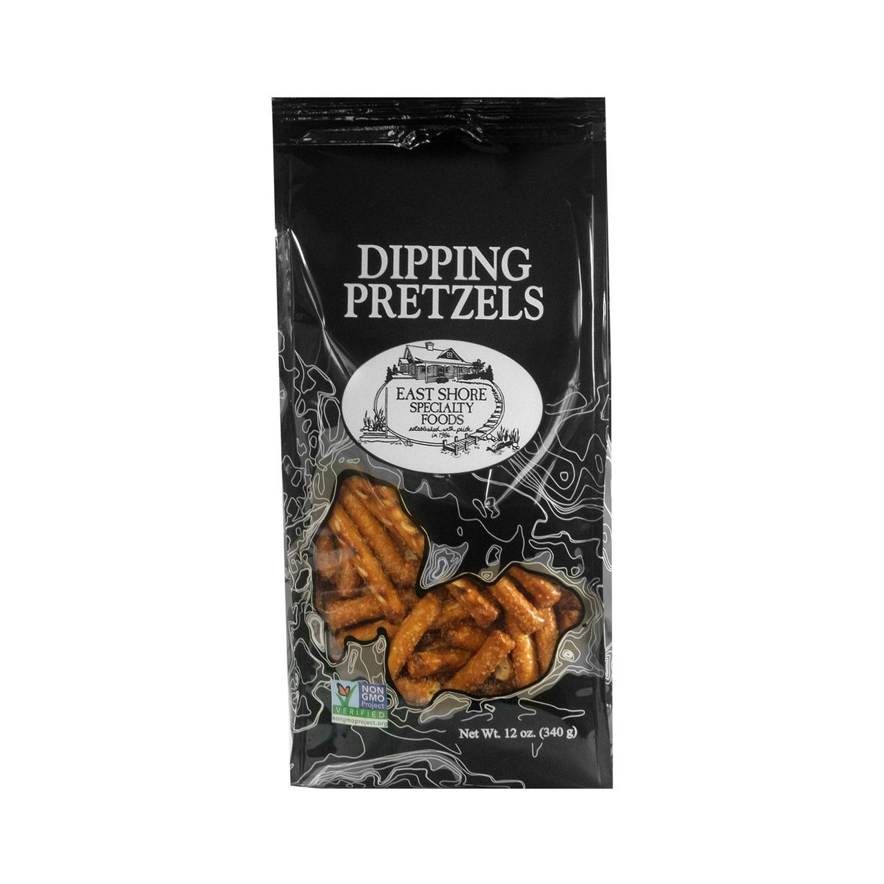 A black stand-up pouch of East Shore Specialty Foods Dipping Pretzels (12 oz / 340 g) isolated on a solid white background. The packaging features the words "DIPPING PRETZELS" in a bold serif font above an oval-shaped logo illustrating a lakeside cottage. Fine white topographical map lines accent the package design, which features a clear window at the bottom revealing thick, golden-brown pretzel sticks alongside a green and blue Non-GMO Project Verified seal.