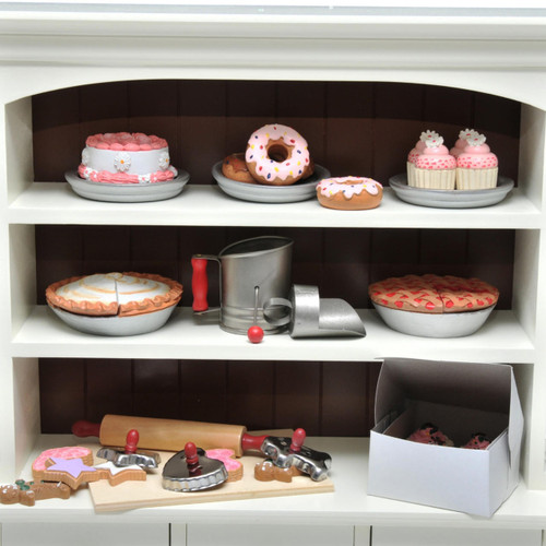 Against white background our 18 inch doll hutch shelves are stocked full with all of our  18 inch doll baked goods and baking tools.