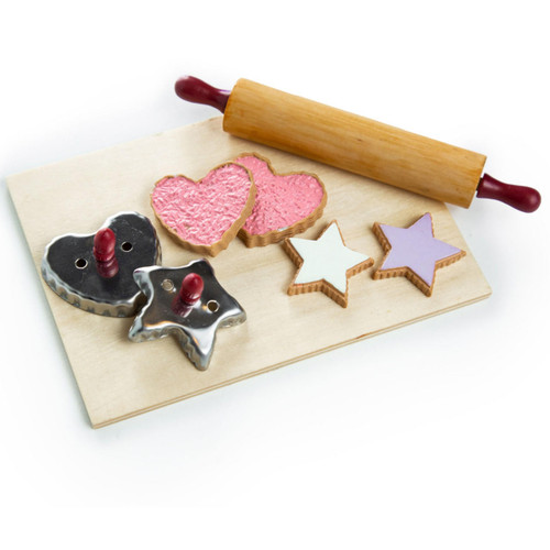 On white background, the wooden breadboard, wooden rolling pin, 2 tin cookie cutters with wooden handles, 2 heart shaped cookies with pink icing and 2 star shaped cookies with light purple icing.