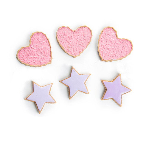 Six toy cookies are arranged in two rows against a plain white background. The top row features three heart-shaped cookies covered in textured pink sprinkles. The bottom row displays three star-shaped cookies with smooth light purple icing.