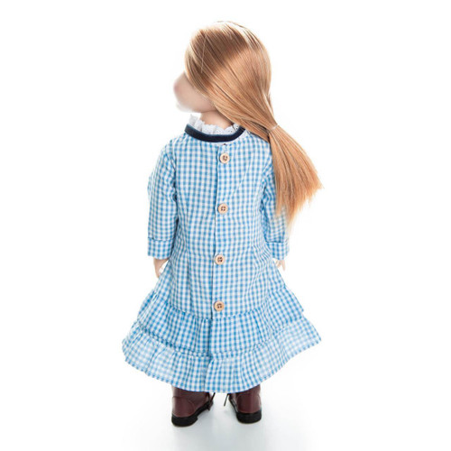 Rear view of a pioneer doll with long brown hair standing against a white background, wearing a blue and white checkered gingham dress fastened with three brown buttons down the back.