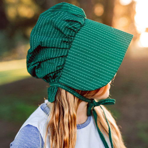 Detail of the green bonnet worn by child model.