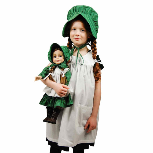 Against white background a girl wearing the child size apron and bonnet set holds an 18 inch doll in the matching prairie dress set. Against white background a girl wearing the child size apron and bonnet set holds an 18 inch doll in the matching prairie dress set.
