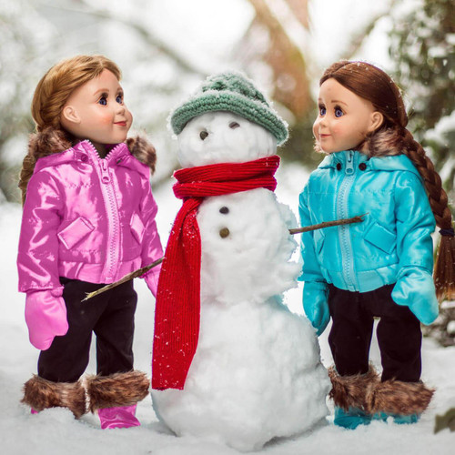 In outdoor play scene, two 18 inch dolls in their matching pink and blue snow clothes sets build a snowman.