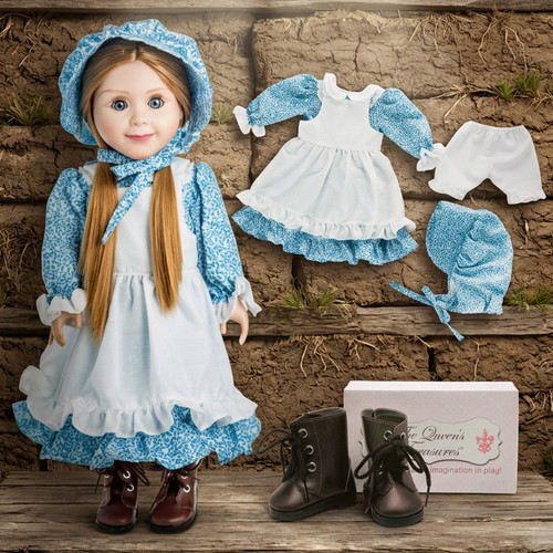 The Queen's Treasures Little House on the Prairie Blue Calico Dress with Brown Lace up Boots for 18" Doll. She is displayed in front of a sod wall, like the first home the Ingalls had on the Prairie.