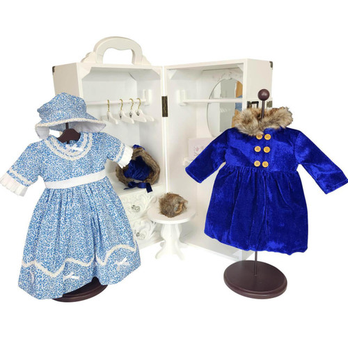 The two blue 18 inch doll clothing outfits and 1 pair 18 inch doll shoes displayed in front of the opened storage trunk for 18 inch doll. The two blue 18 inch doll clothing outfits and 1 pair 18 inch doll shoes displayed in front of the opened storage trunk for 18 inch doll.