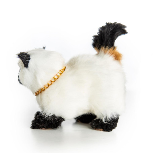 Side view of the Siamese kitty. 18 inch doll pet has white fur with black paws, tail, and ears.
