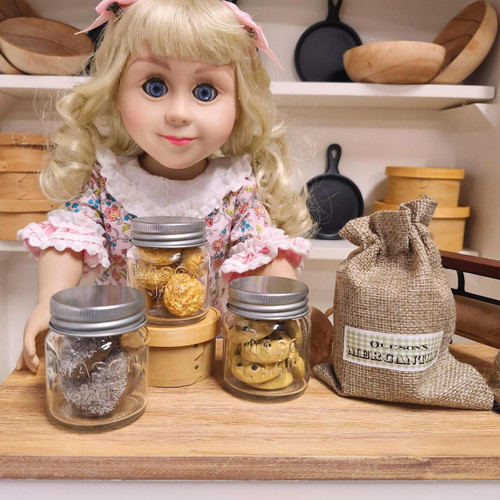 Nellie doll standing at country with 3 mini mason jars filled with 18 inch doll cookies.