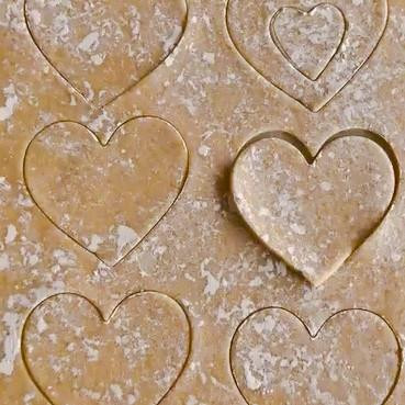 Rolled dough with heart shaped cookie cut outs
