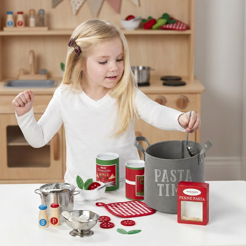 Child with pasta play set pretending to cook
