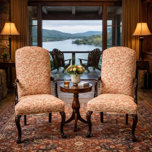 Pair of Southwood Queen Anne mahogany armchairs flanking tea table in a cozy rustic lodge room