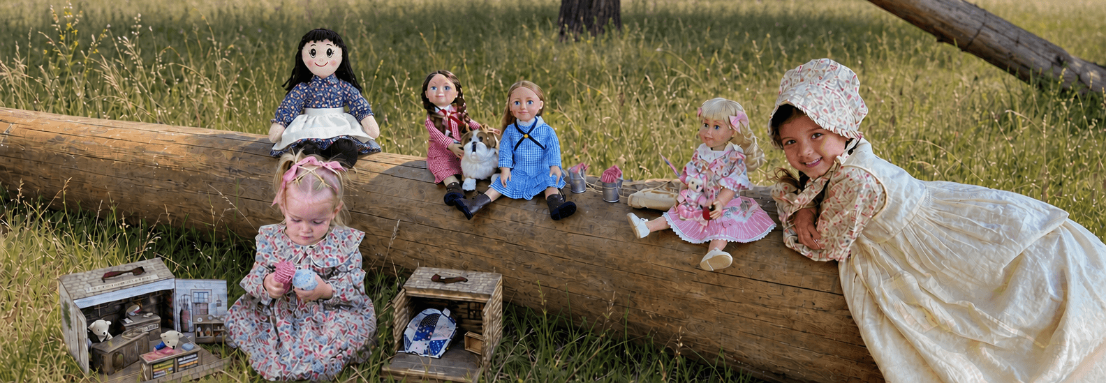 Girl laying on a log with little house on the prairie dolls and a smaller child sitting in front of the log with 2 sets of our Little House on the Prairie Bear playset