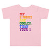 Pink Toddler shirt with bold rainbow text that reads "My 2 Moms Are Cooler Than Your 1," perfect for pride celebrations and everyday wear.