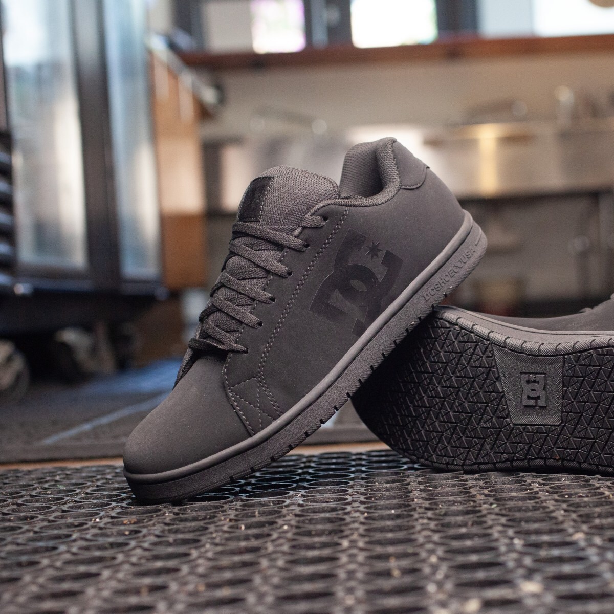 dc60401-dc-img-2010-square.jpg Pair of DC soft toe work shoes posed in the middle of a restaurant kitchen floor.