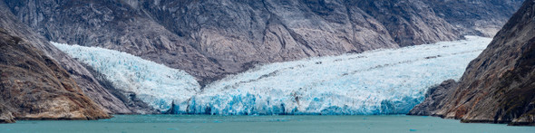 A panoramic image of Dawes Glacier converging into the waters of the Endicott Arms Fjord