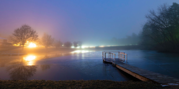 lights in a fog with a dock in the foreground