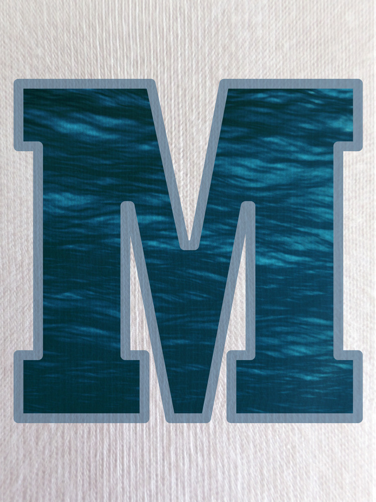 Close-up of the ocean print within the ‘M’, showcasing rich blue tones and soft water-like movement